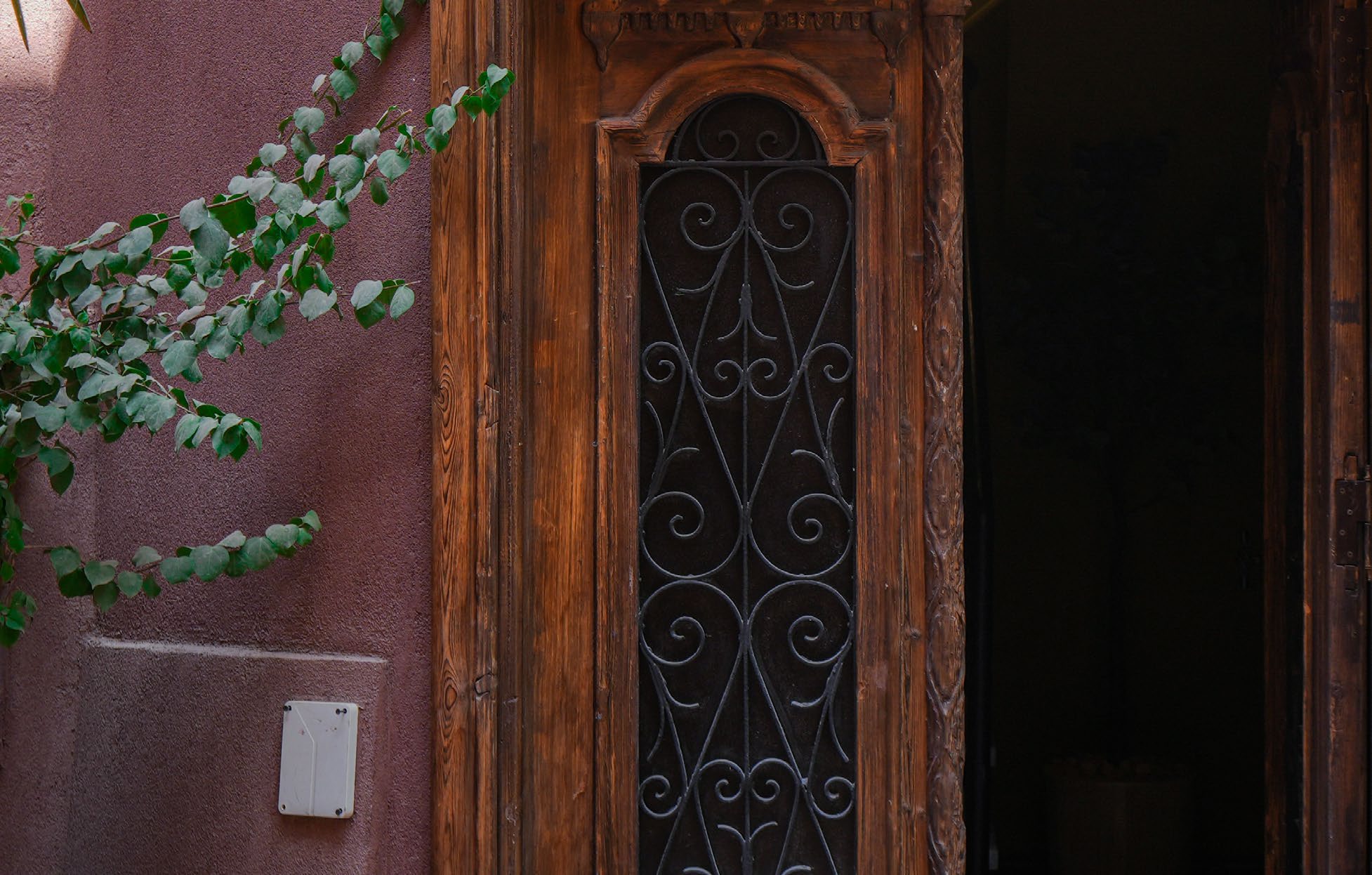 The Atouta Suite — carved wooden door and wrought-iron grille