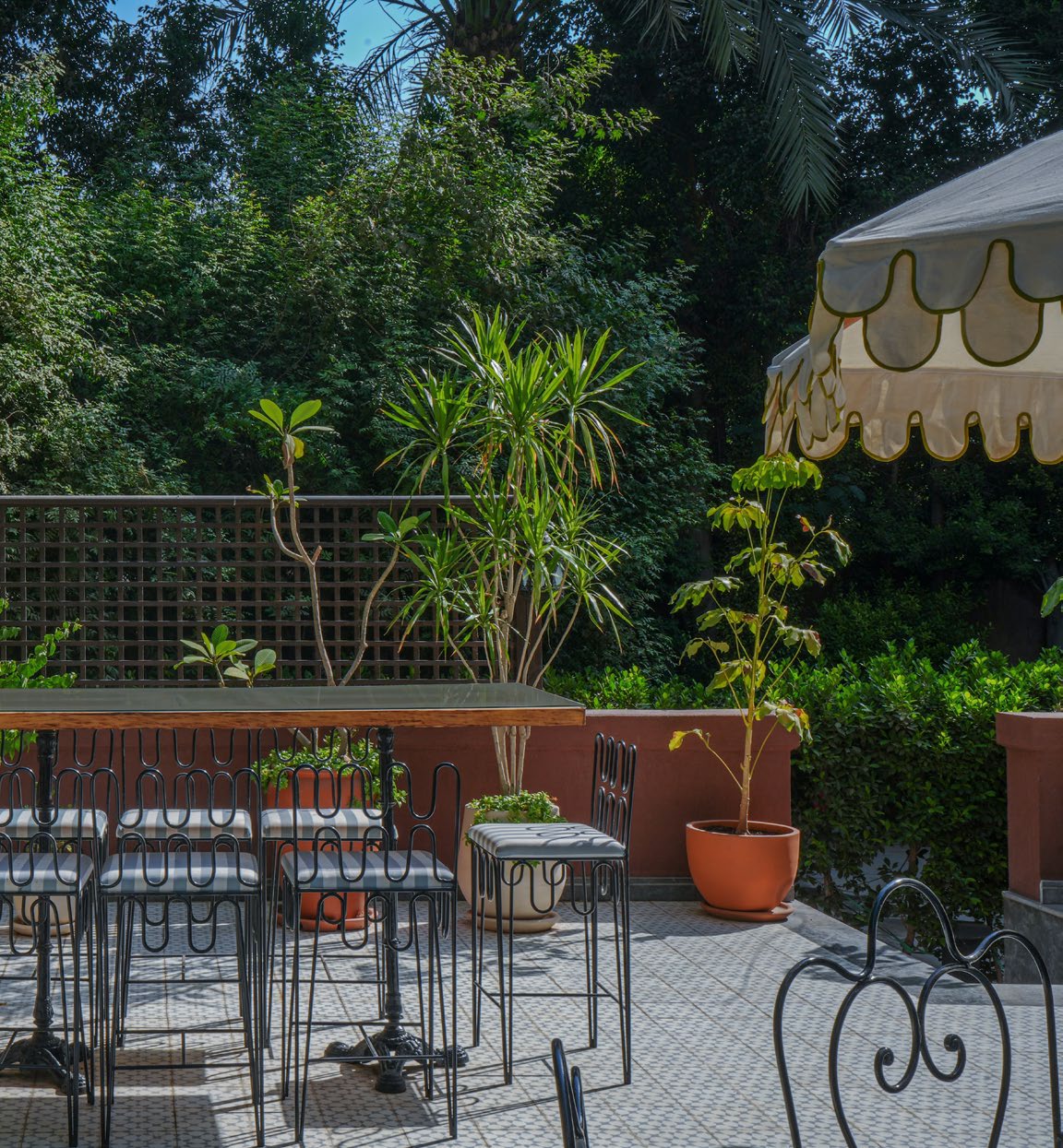 Garden Studio — terrace seating under a scalloped parasol